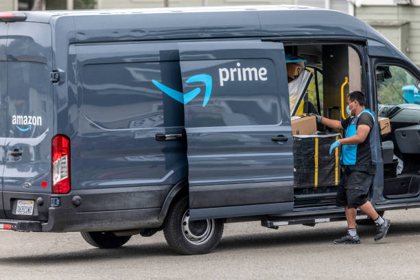 Amazon Delivery Covid 19 Pacifica California, USA - May 11, 2020: An Amazon Prime delivery driver wearing personal protective equipment delivers packages during the shelter in place order and quarantine. amazon.com photos stock pictures, royalty-free photos & images