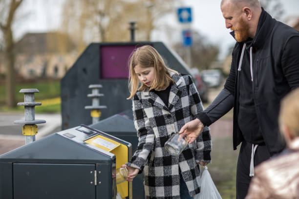 istock Father and daughter recycling trash goods 1233029011