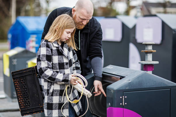 istock Father and daughter recycling trash goods 1233033743