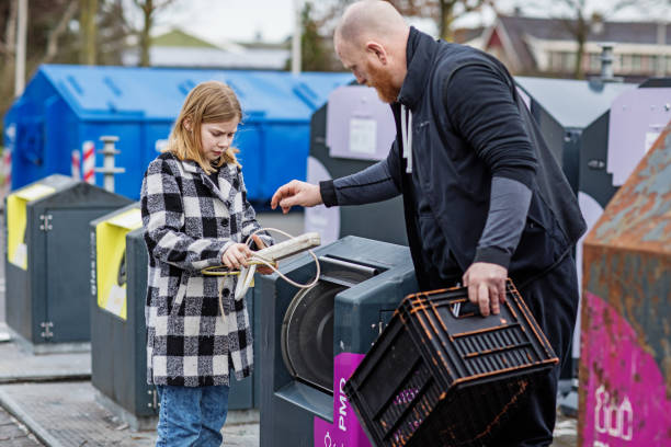 istock Father and daughter recycling trash goods 1233036824