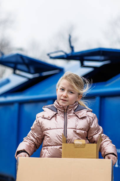 istock Young girl at a paper recycling centre 1233037876