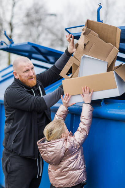 istock Father and daughter recycling paper 1233042512