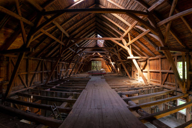 istock Interior of large old timber frame barn in Germany during renovation, upper floor wide angle shot 1233057404