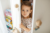 Little girl hiding in the closet