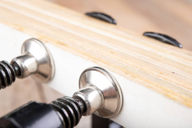 istock Carpentry clamp used for gluing wood. Small carpentry work in a home workshop. Light background. 1233086145