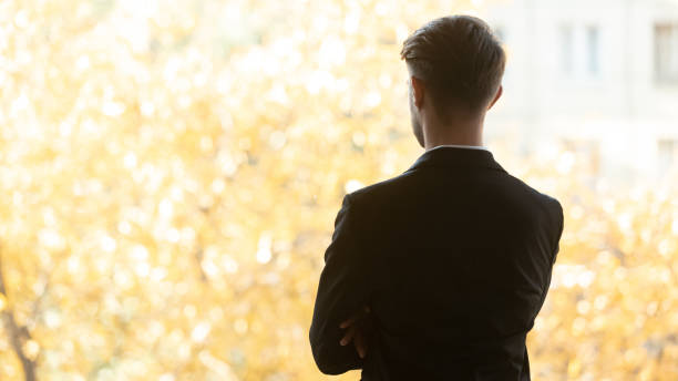 istock Thoughtful company owner looking out the window at autumn scenery 1233104976