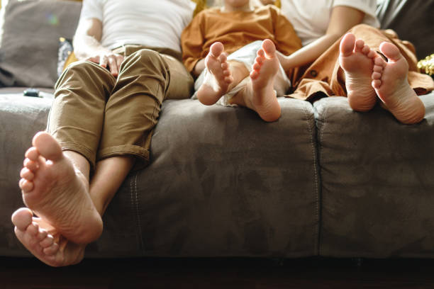 istock Barefoot family sitting on the sofa 1233112134