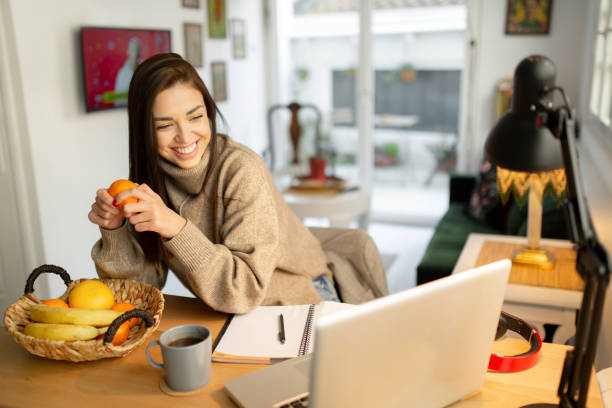 istock Happy young woman casually working from home 1233141644