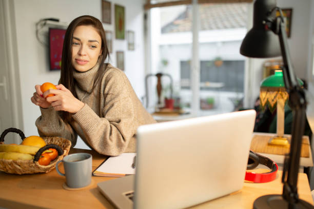 istock Happy young woman casually working from home 1233142663