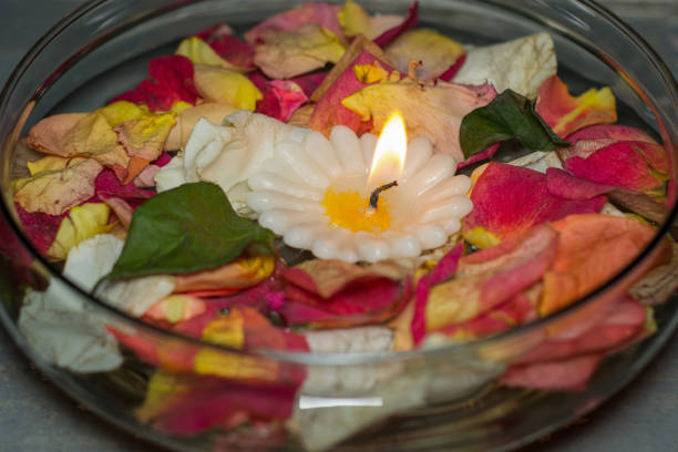 istock candle and flowers over cristal cup 1233152044