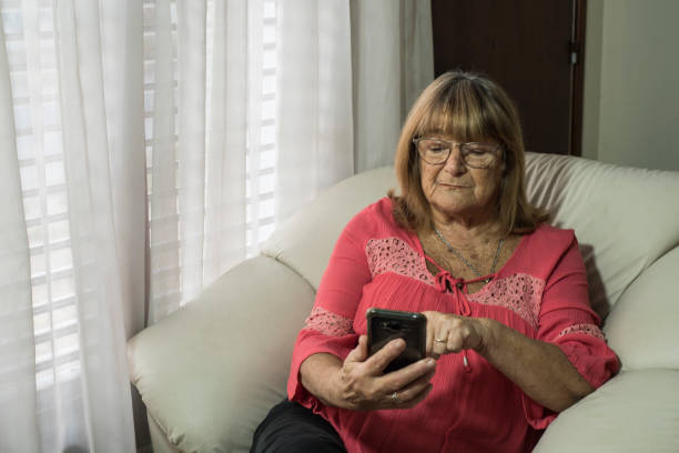 istock older woman using modern technologies on her devices to communicate while meeting social distancing 1233168741