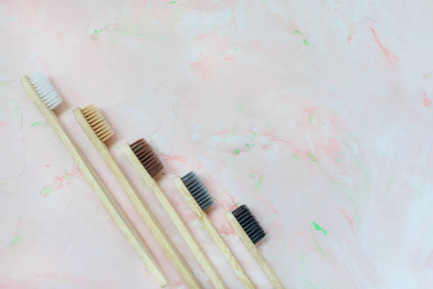 istock Five natural wooden bamboo toothbrushes on pink 1233169772