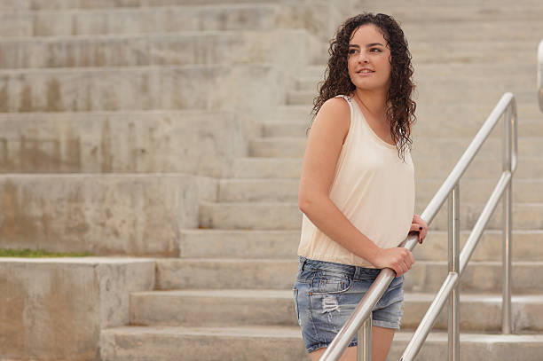 istock Young woman on a staircase 123321701