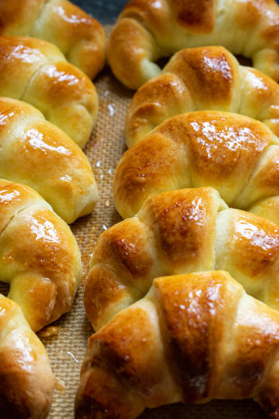 istock Argentine croissants, medialunas de Manteca over silicon pastry mat. Vertical 1233225868