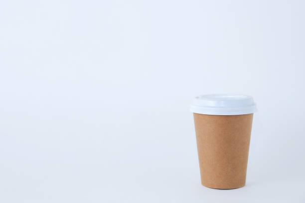 istock Paper brown cup of coffee close-up on a white background. 1233228759