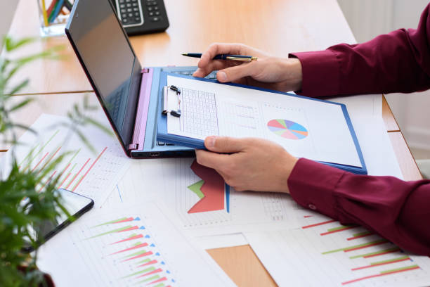 istock close-up of the office worker holding a tablet with documents and graphs 1233255846