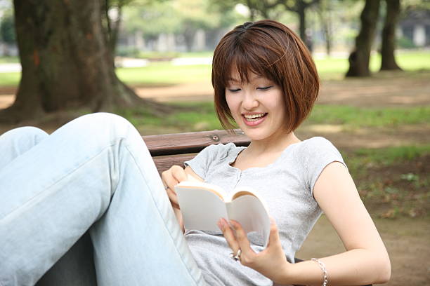 istock asian young woman reads a book 123334675