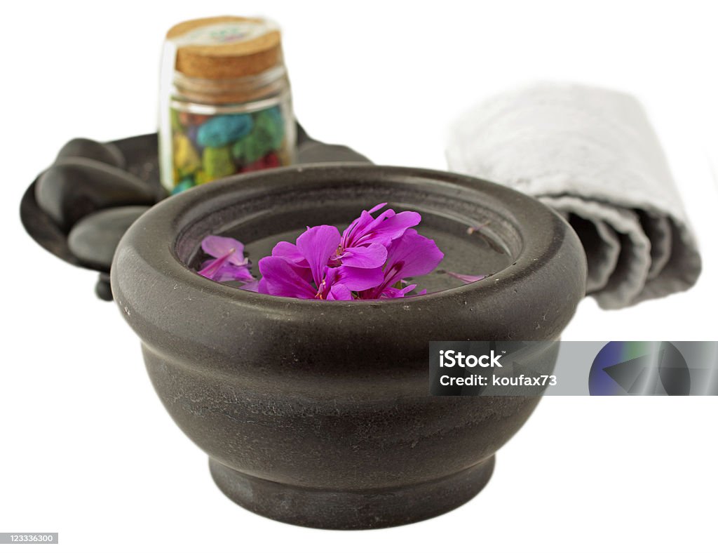 Decoration Stone cup with geranium, with towel and bath salt on the back Aromatherapy Stock Photo