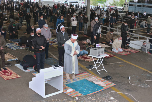 Distanced Muslim men praying in jumah prayer after 3 months quarantine in Turkey stock photo
