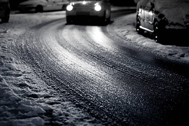 Street at night - covered with a layer of ice, selective focus - traffic