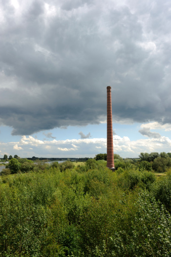 The obsolete smoke stack or chimney of an old brickyard along the river IJssel in The Netherlands
