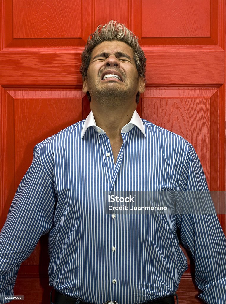 Stressed man Very stressed man leaning on a red door (this picture has been taken with a Hasselblad H3D II 31 megapixels camera) 30-39 Years Stock Photo