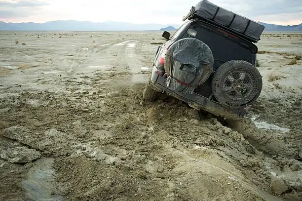 Photo of 4x4 stuck in the mud at sunset, Nevada, US