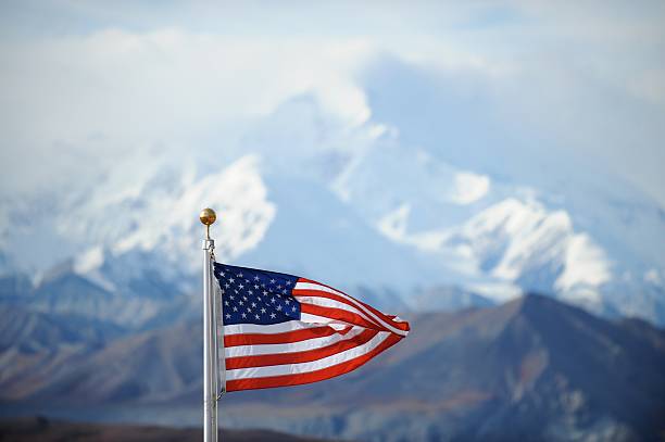 istock US flag flying with snowy Mount Mckinley in background 123344399