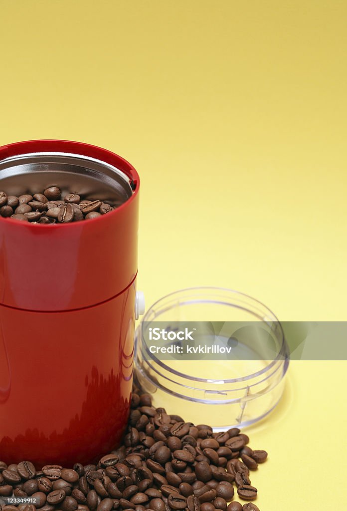 Electric Coffee Grinder Lot of coffee beans near open modern red grinder on yellow background Coffee Grinder Stock Photo