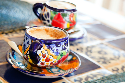 Cappuccino in traditional colorful mexican pottery cups