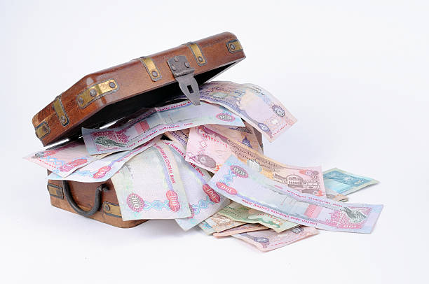 money box UAE currency flowing out from a wooden treasure box.  Related images; http://www.istockphoto.com/file_search.php?action=file&lightboxID=4908507 moroccan currency photos stock pictures, royalty-free photos & images