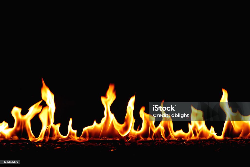 flames a row of fire flames over hot stone.  Backgrounds Stock Photo