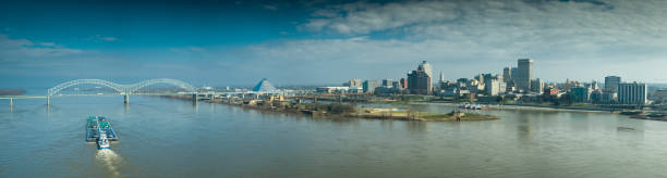 Drone Panorama of the Hernando de Soto Bridge, Mud Island and Downtown Memphis Drone shot of a barge on the Mississippi, approaching the Hernando de Soto Bridge connecting Memphis, Tennessee and Arkansas. stitched image stock pictures, royalty-free photos & images