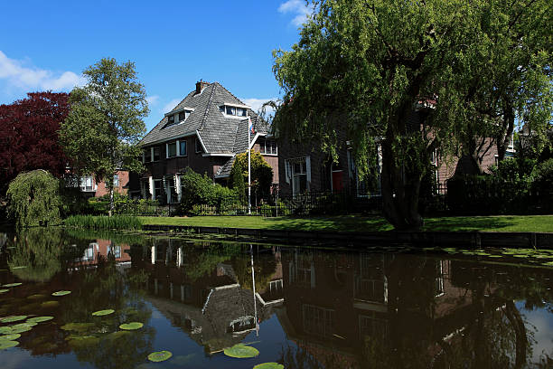 istock detached houses with their reflection in the water 123356388