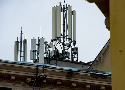 Bucharest, Romania - May 15, 2020: Many GSM telecommunications antennas are installed on top of a building in Bucharest. This image is for editorial use only.