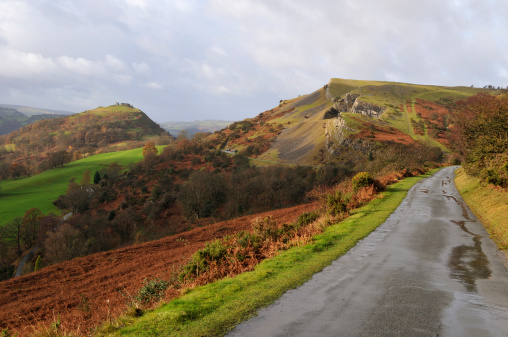 A small Welsh lane hugging the hillside, with Castell Dinas Bran in the distance.