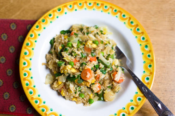 istock Bowl of Fried Rice and Vegetables Close Up with Fork 1233713600