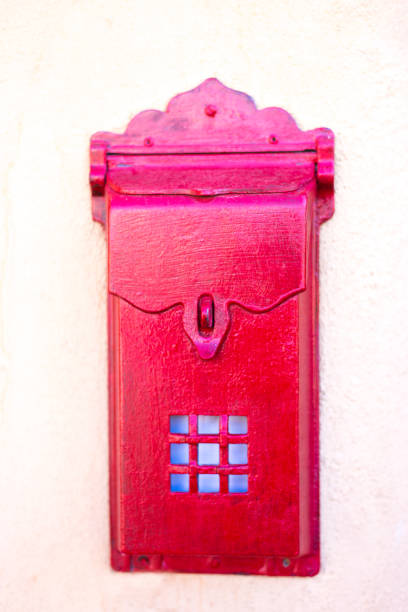 istock Old-Fashioned Red Mailbox on Off-White Wall Close-Up 1233714605