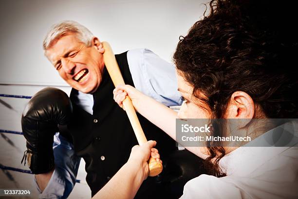 Young Woman Beating Business Man Stock Photo - Download Image Now - Active Seniors, Adult, Aggression