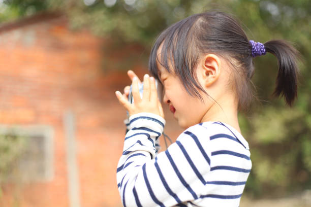 istock a Asian girl taking photos with a digital camera. 1233743387