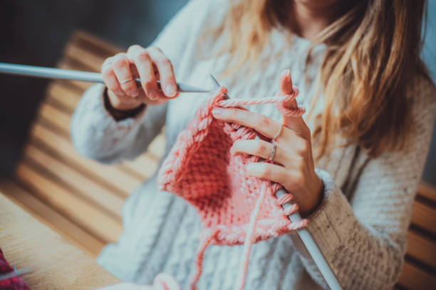 istock Close up on woman's hands knitting 1233749427