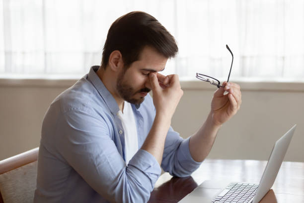 istock Stressed young businessman taking off glasses, suffering from eyes strain. 1233750967