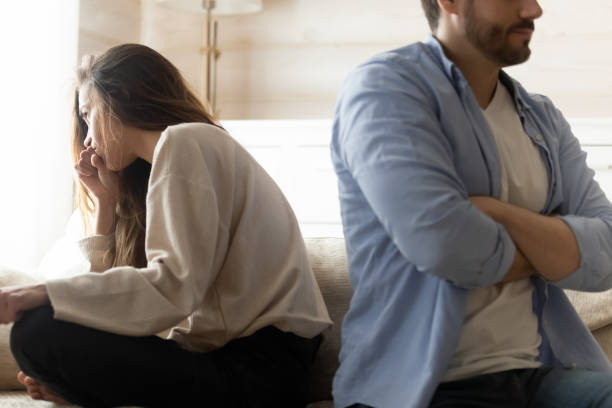 Stressed young married couple ignoring each other after quarrel.