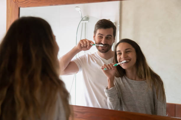 istock Young family couple having fun while cleaning teeth together 1233751562