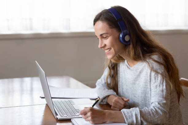 istock Happy millennial woman enjoying studying remotely at home. 1233752031