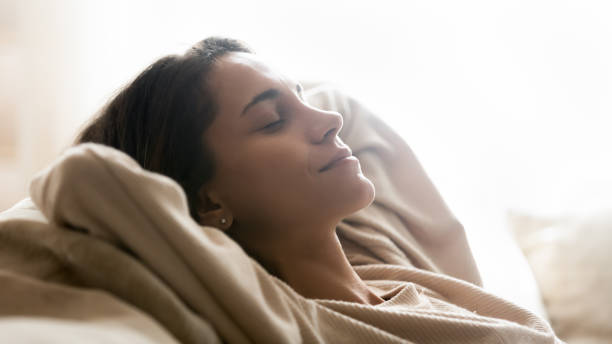 istock Serene young mixed race girl resting daydreaming on cozy sofa. 1233752041