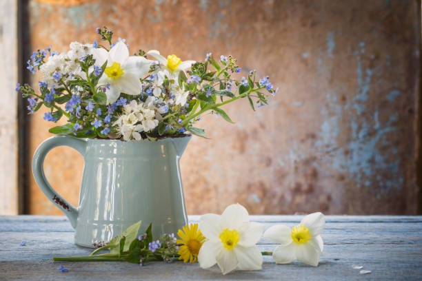 istock spring flowers in jug on old wooden painted background 1233753104