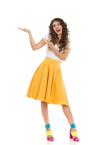 istock Beautiful Woman Is Holding Hand Raised And Pointing At It 1233758801