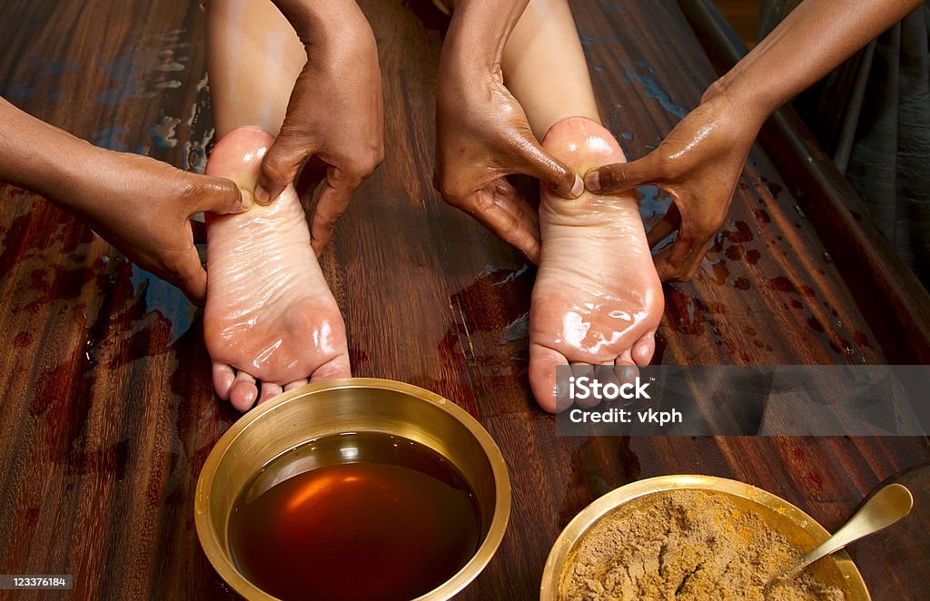 traditional indian ayurvedic oil foot massage indian doctors doing traditional ayurvedic oil foot massage Ayurveda Stock Photo