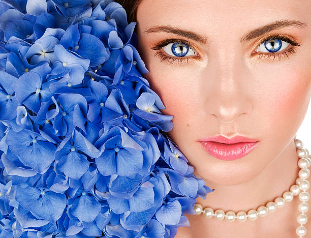 Beautiful young woman with blue flowers